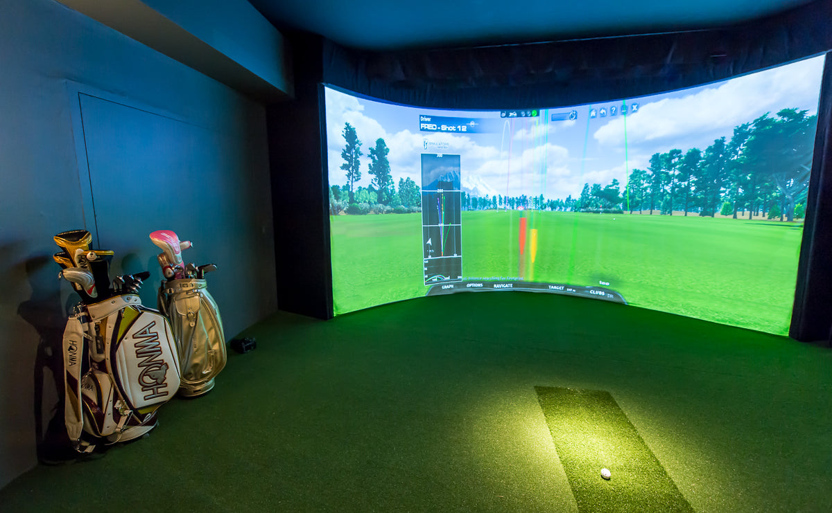 Golfer using an aboutGOLF curved-screen simulator